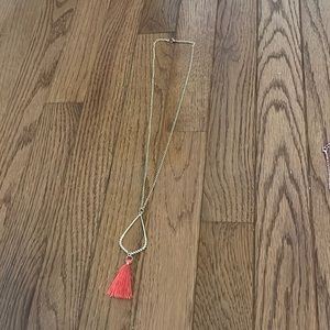 gold necklace with pink pom pom